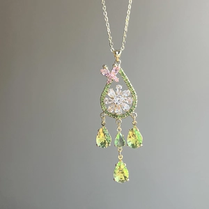 Elegant gold drop earrings with pink zircon butterfly, white flowers and green gems