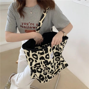Macro shot of durable canvas texture and leopard print on large capacity tote bag