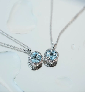 Macro shot of 925 silver necklace with square aquamarine pendant and pavé diamonds