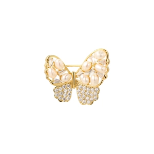 Macro shot of butterfly brooch with gold plating, white pearls and zircon stones