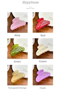 Detailed collection of pearl-embellished hair claws in six elegant colors on a wooden surface