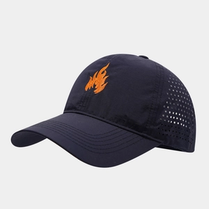 Detail view of flame embroidery and laser-cut ventilation on a navy quick-dry sports cap