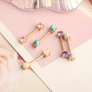Macro view of heart-shaped zircon nipple rings with various colorful gemstones in rose gold