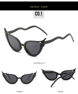 Close-up of cat-eye sunglasses featuring unique snake-shaped temples and scale textures