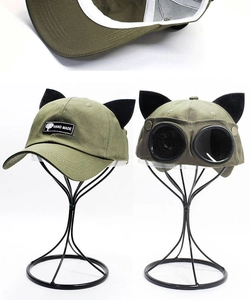 Detail view of olive green pilot baseball cap with cat ears and built-in aviator goggles