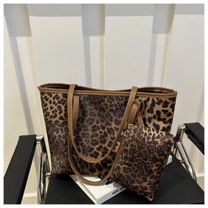 Leopard print tote bag set with matching small purse placed on a white book