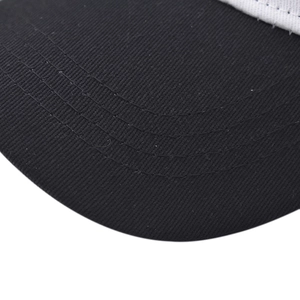 Detail shot of the black cotton baseball cap brim showing reinforced multi-row stitching