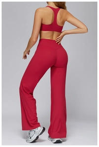 Back view of high-waist flared yoga pants and racerback sports bra in dark red matte fabric
