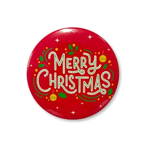 Macro shot of 58mm Merry Christmas tinplate badge with festive holly and red design