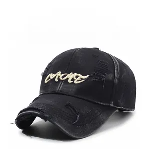 Close-up of distressed black washed cotton baseball cap with vintage embroidery details