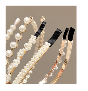 Detail of cream white pearl headbands for girls with gold alloy and woven pearl textures