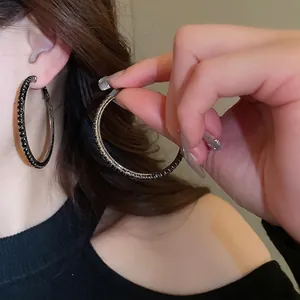 Chic oversized hoop earrings with black micro-paved diamonds in a gunmetal finish