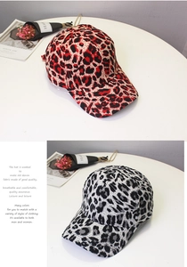 Detail view of red and grey leopard print baseball caps in washed denim fabric