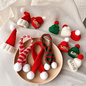Miniature red and green knitted Christmas hats and scarves with LOVE embroidery