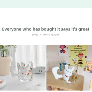 Macro view of clear glass mug with 3D rabbit figurine handle and fruit patterns