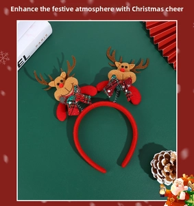 Detail of red Christmas headbands with plush reindeer and plaid bows on a festive background