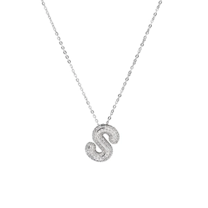 Close-up of silver balloon letter S pendant necklace featuring sparkly crystal pave stones