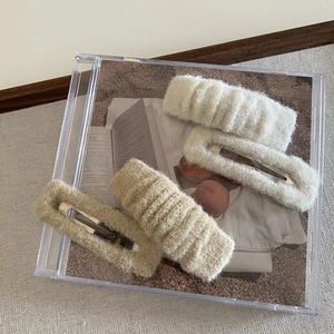French style plush hair clip set of 4 in cream and camel knit fabric on a CD case