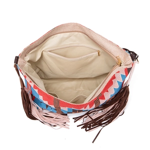 Internal view of bohemian tassel bag showing beige lining and zipper pocket detail