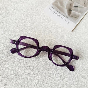 Macro shot of stylish purple transparent thick frame glasses with irregular round design