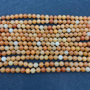 Detailed view of natural Red Aventurine round stone beads for jewelry making