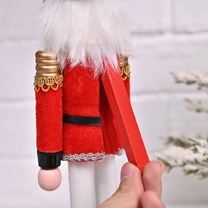 Close-up of the wooden nutcracker manual lever mechanism with red velvet and gold details