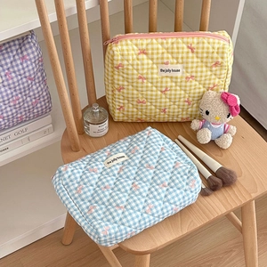Quilted checkered cosmetic bags with bow patterns in yellow and blue colors