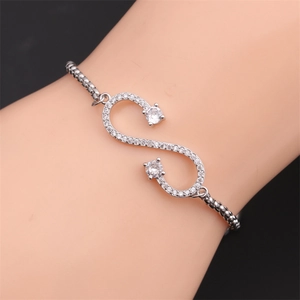 Silver infinity symbol bracelet with pavé cubic zirconia worn on the wrist