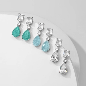 Elegant teardrop earrings with square and round gemstones in green, blue, and clear colors