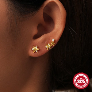 Elegant S925 sterling silver gold star and flower earrings with zircon stones on model
