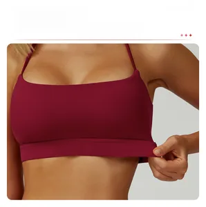 Detail of cross back yoga bra with wide elastic band and removable pads in deep red