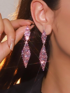 Detailed view of luxury long tassel earrings with sparkling pink and purple crystals