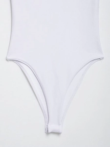 Detail of white bodysuit showing high-cut design and fine ribbed knit fabric texture