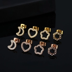 Set of four pairs of star, heart, moon and hexagon stud earrings in gold and rose gold