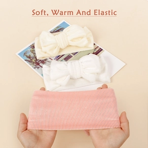 Soft ribbed baby bow headbands in cream and pink showing high elasticity and stretch
