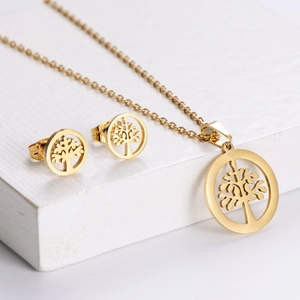 Élégante parure de bijoux arbre de vie dorée avec collier et boucles d'oreilles sur socles