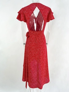 Detail view of the open back cutout and ruffle sleeves on the red polka dot dress