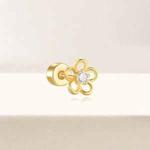 Detail of gold flower cartilage earring with a sparkling center zircon and flat back screw