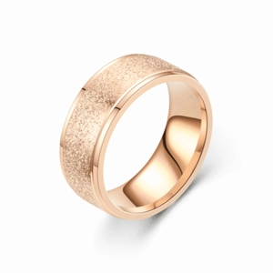 Detail of rose gold titanium ring featuring frosted sandblasted texture and polished edges