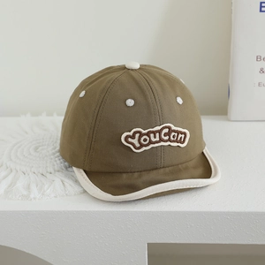 Detailed close-up of dark khaki baby cap with YouCan embroidery and soft brim texture
