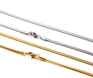 Detail view of gold and silver snake bone necklaces with secure lobster clasps