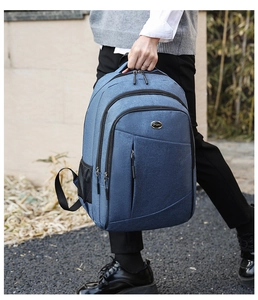 Blue oxford fabric backpack with multiple zipper compartments and side mesh pockets
