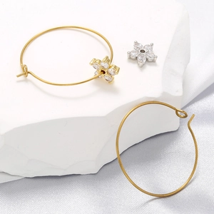 Micro-inlaid zircon flower pendants with 18K gold-plated earring hooks on white stone