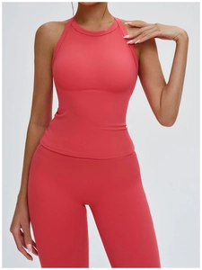 Detail of coral red yoga set with racerback halter top and high-waisted leggings
