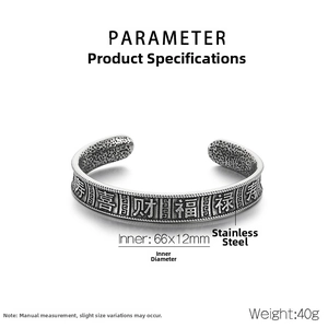 Detail of vintage stainless steel cuff with engraved characters and inner hammer texture