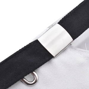 Detail of adjustable metal buckle and black twill strap on a cotton baseball cap