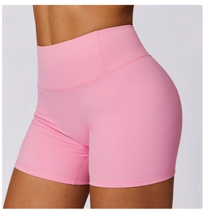 Detail of pink high-waisted yoga shorts showing professional stitching and matte stretch fabric