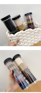 Detail of high-elasticity hair ties in a portable clear jar with Morandi color palette
