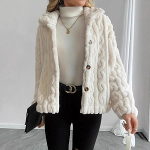 Detail of white plush jacket showing chunky knit texture and large lapels with buttons