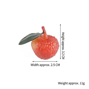 Realistic PVC lychee model with red textured skin and green leaves, 3.2cm x 2.5cm size